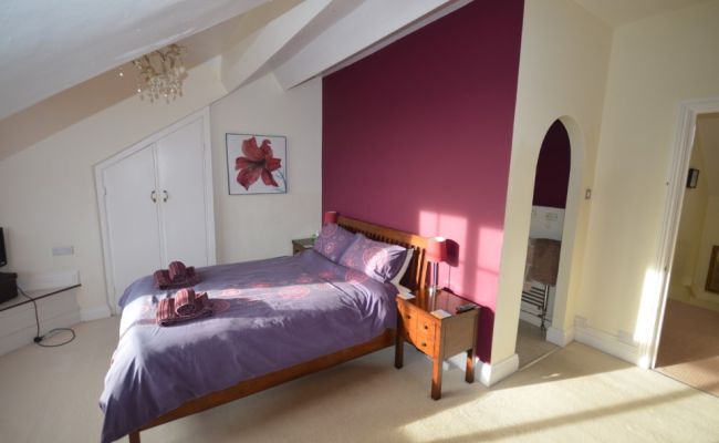 Bedroom with king sized bed and ensuite.